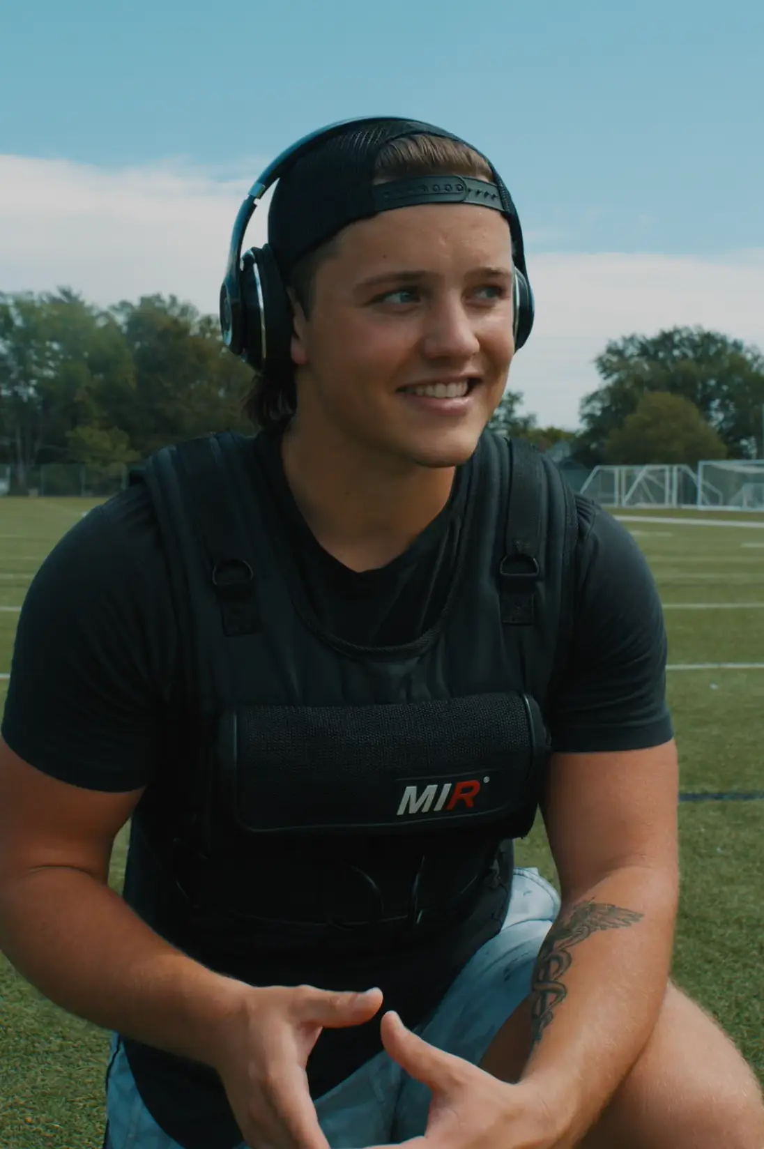 Adrian sitting on a field after training